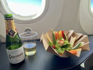 sparkling wine and salad on Zipair business class