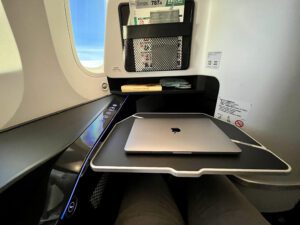 Zipair business tray table with laptop